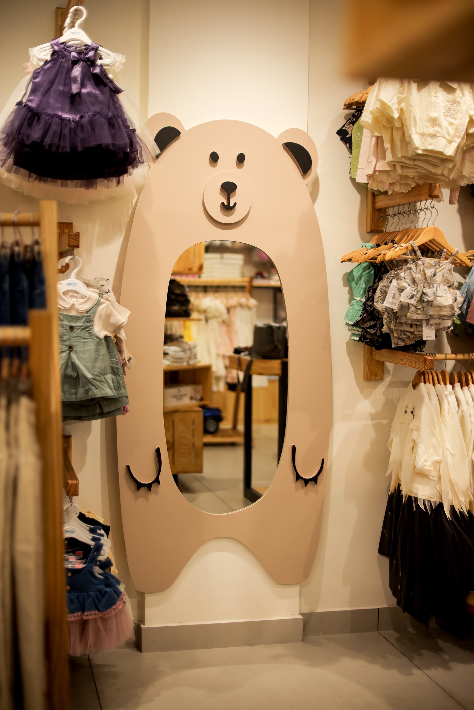 Bear-shaped fitting-room mirror within Amie's Studios