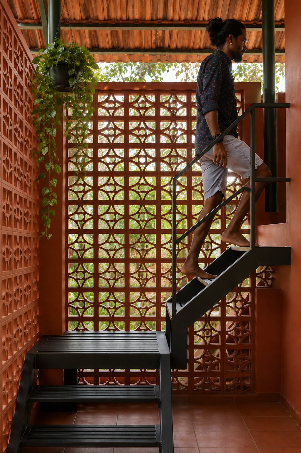 Edam staircase framed by terracotta jaali walls and greenery
